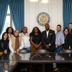 Students and administration at New Brunswick City Hall standing together in a group photo