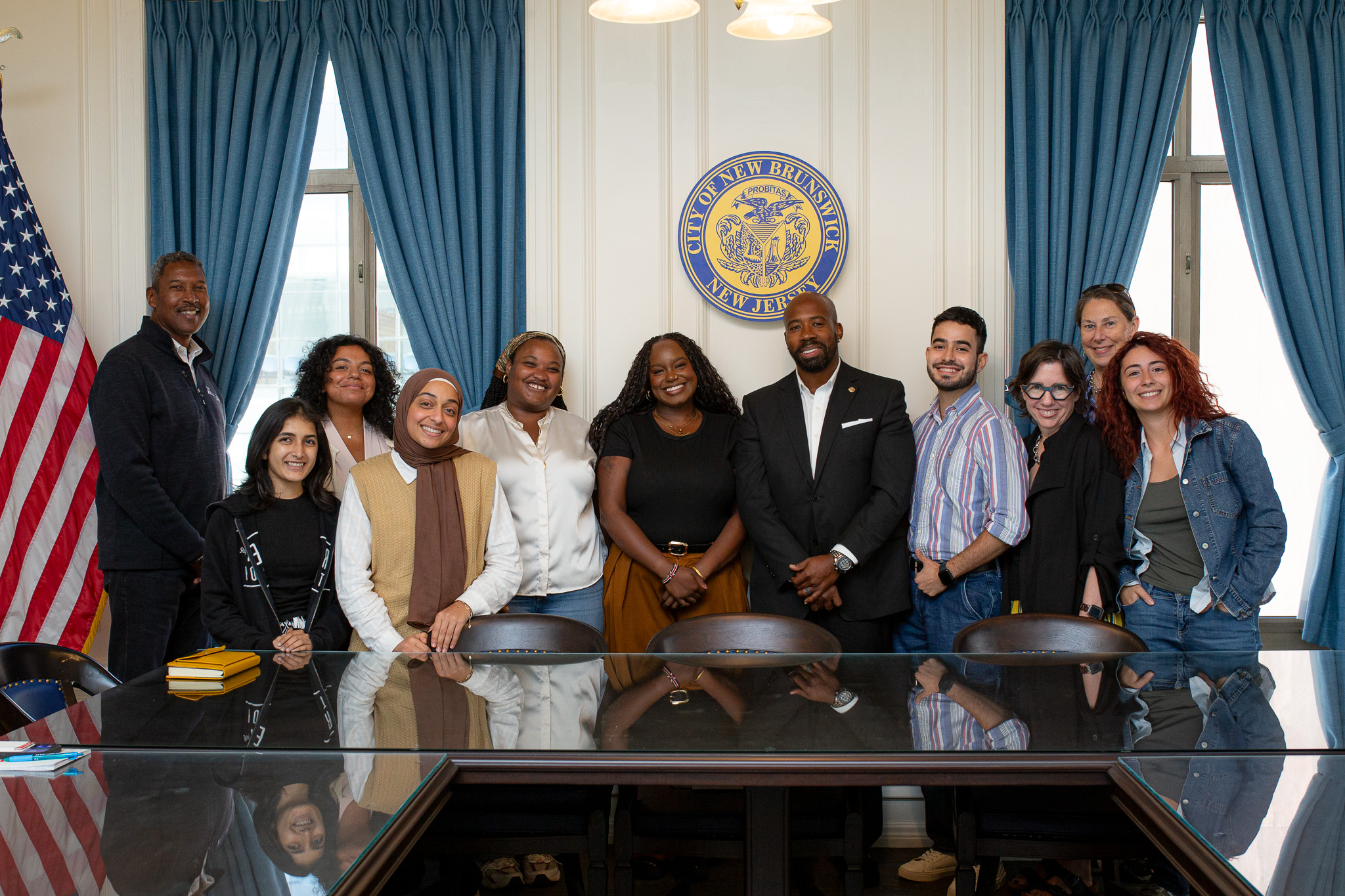 Students and administration at New Brunswick City Hall standing together in a group photo 