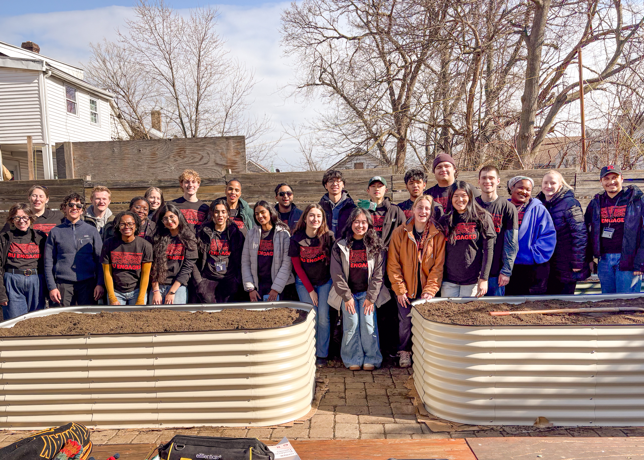 group in community garden in front of raised garden bed